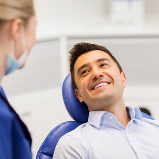 Smiling male patient learning about his cosmetic dentistry options