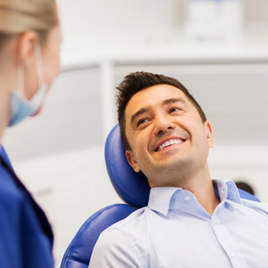 Smiling male patient learning about his cosmetic dentistry options