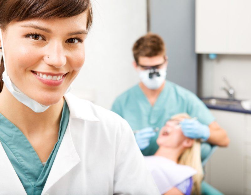 Dentist and dental team member providing preventive dentistry