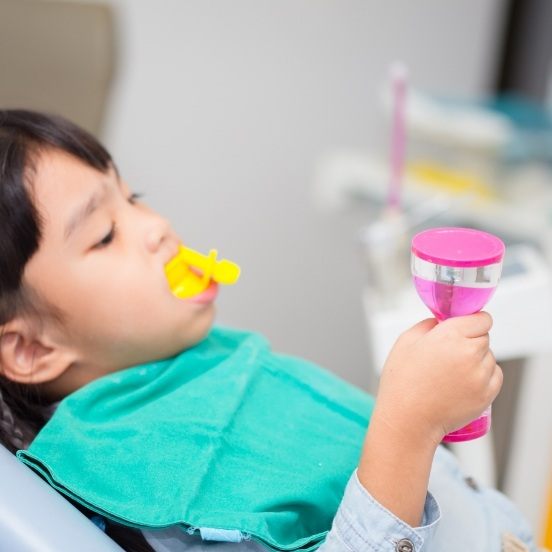 Young dental patient receiving silver diamine fluoride treatment
