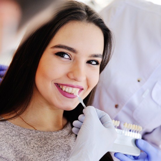 Woman's smile compared with porcelain veneer shade