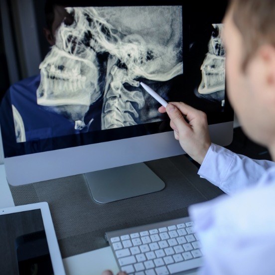 Dentist examining digital x-rays